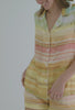 A lady wearing multi color short sleeve classic shorty woven silk pj set with island sunset print.