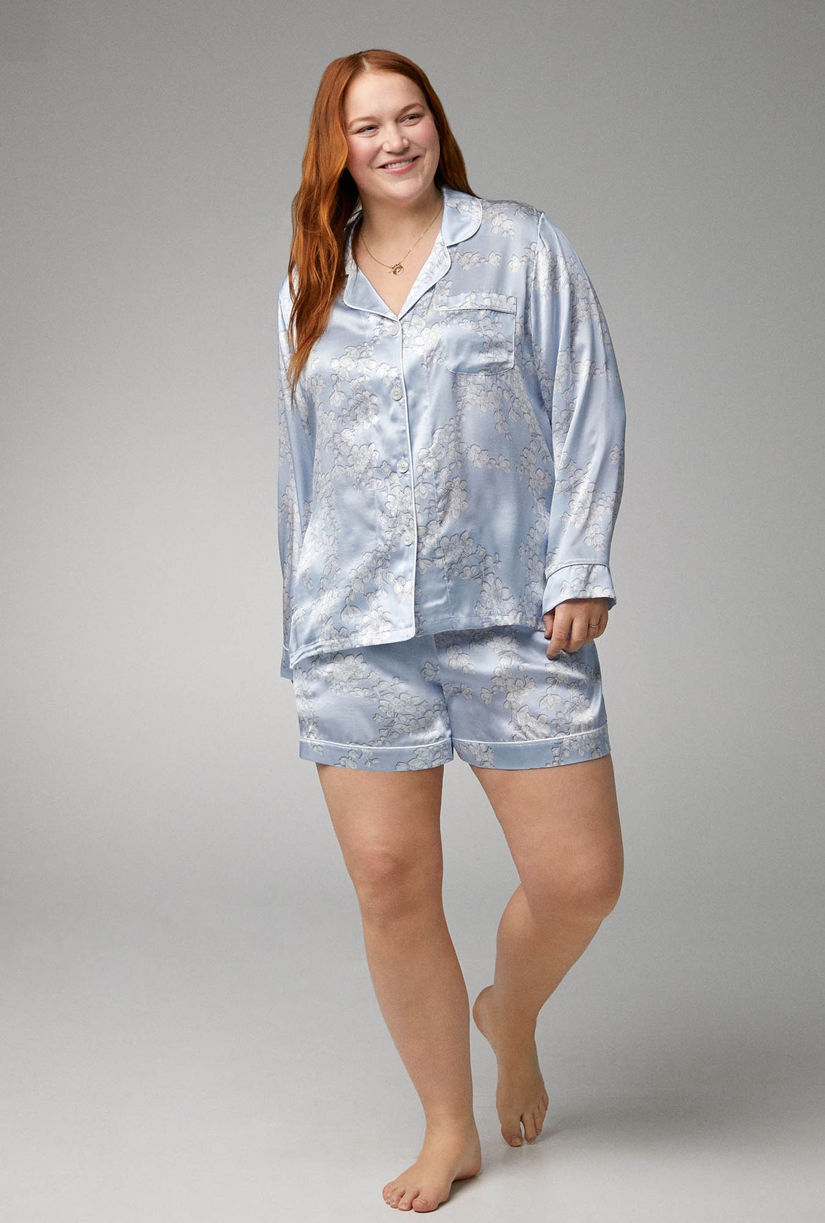 A lady wearing blue long sleeve classic woven silk satin shorty pj set with renee&#39;s blossom print