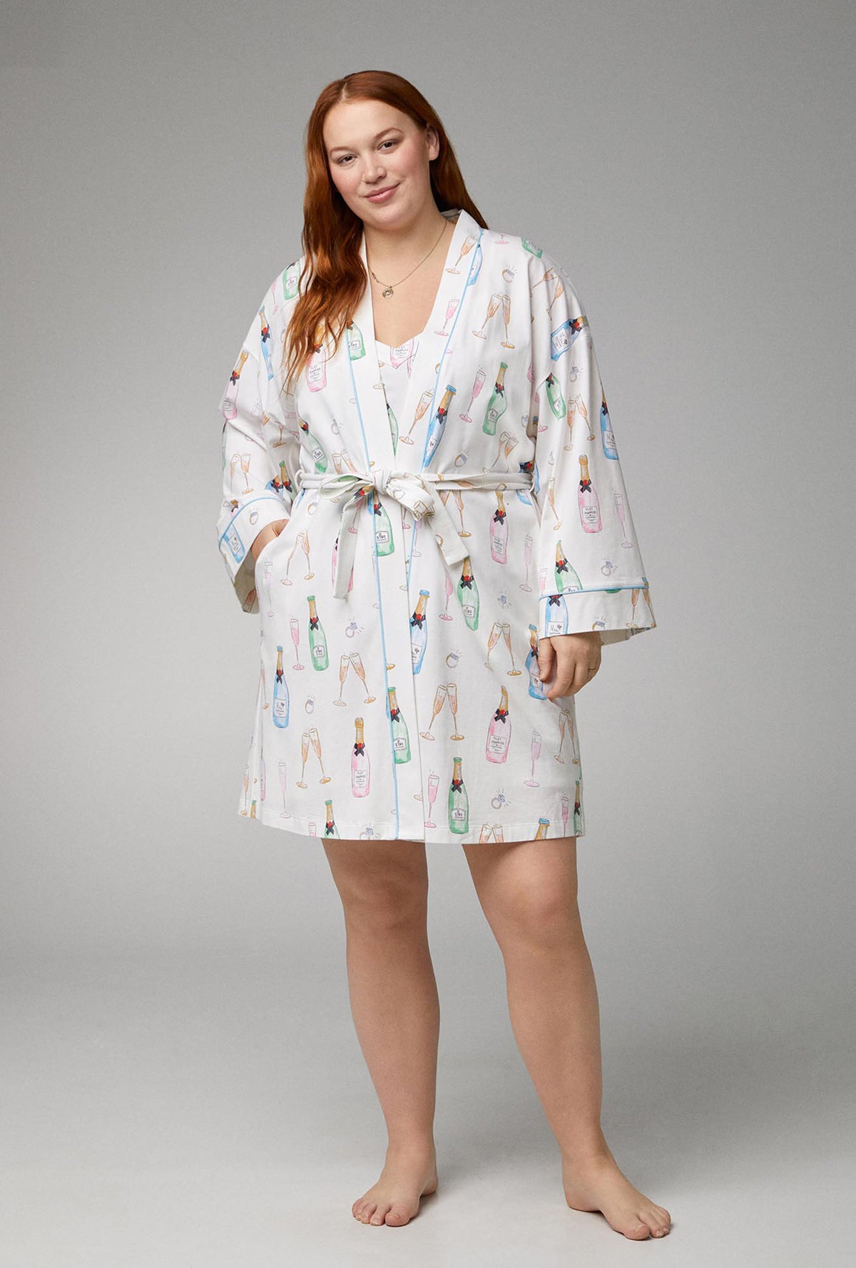 A lady wearing white Banded Collar Stretch Jersey Robe with Champagne Wedding print